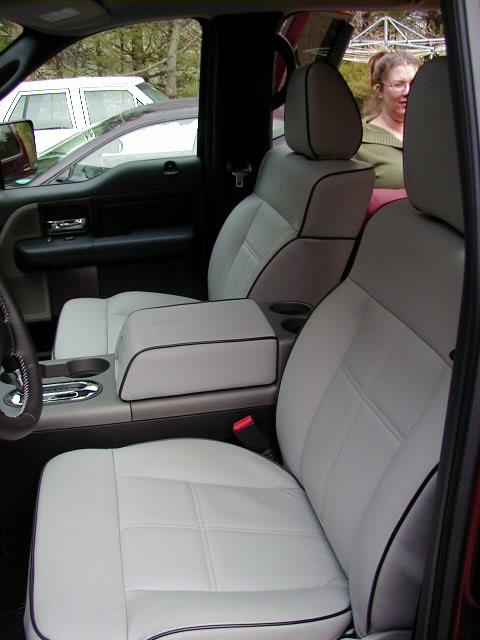 1994 Ford Probe - Interior view of a truck's front seats, with a woman visible through the rear window.