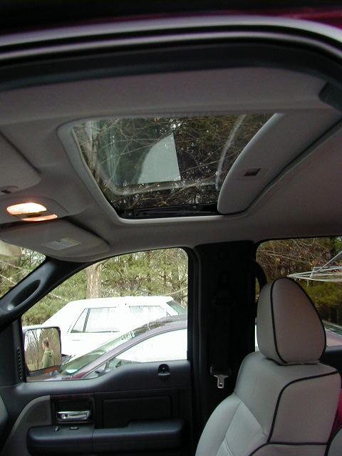 1994 Ford Probe - Pickup truck interior with sunroof open, showing passenger seat and exterior vehicles.