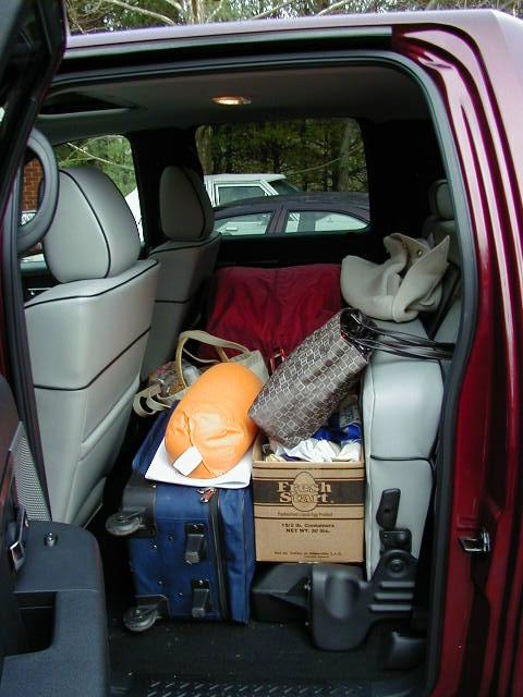 1994 Ford Probe - The back of a vehicle is filled with luggage and other items, suggesting a trip or move.