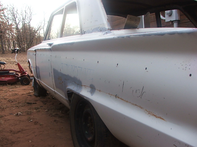 White 1963 Ford Fairlane sedan, side view, showing bodywork and rust