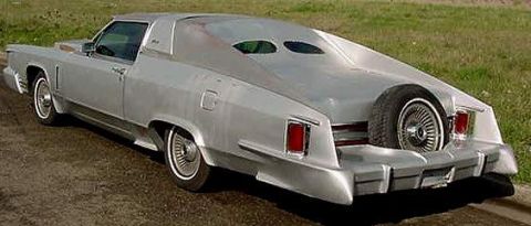 1972 Ford Ranchero - This heavily modified silver car does not resemble a 1972 Ford Ranchero, a unique rear-mounted spare tire and unusual window design.