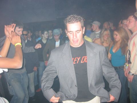 1989 Ford Bronco - A group of people are dancing in a club, with a man in a suit jacket in the foreground.