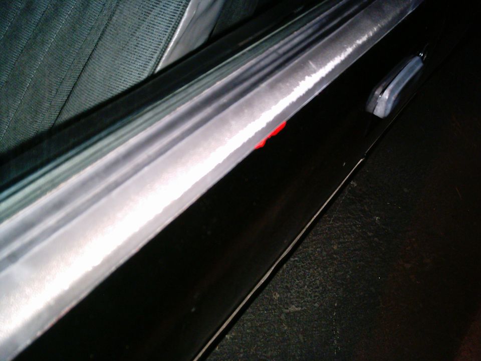 Close-up of a car's interior door panel and seat fabric
