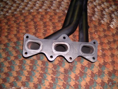 1994 Ford Probe - This is an exhaust manifold, a component of a vehicle's exhaust system.