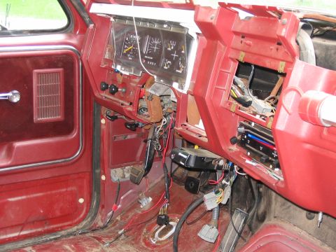 1985 Ford F-350 - The interior of a truck shows a disassembled dashboard with exposed wiring and gauges, indicating repair or modification.