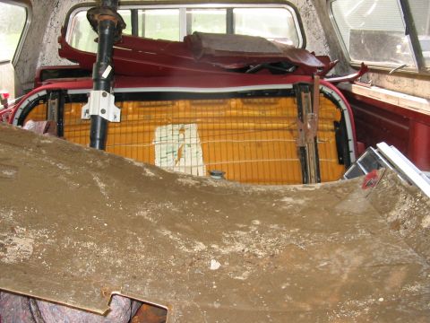 1985 Ford F-350 - The interior of a pickup truck is filled with disassembled parts and debris.