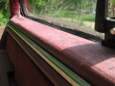 1985 Ford F-350 - Close-up view of the interior door panel and window frame of a vehicle.