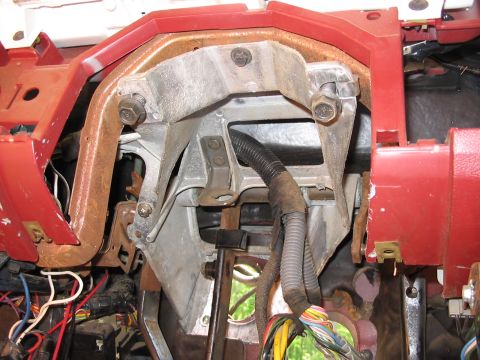 1985 Ford F-350 - The inner workings of a vehicle's dashboard are visible, showing a complex network of wires and mounting hardware.
