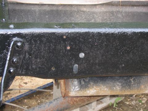 1985 Ford F-350 - Close-up view of a truck's frame, showing structural details and some surface rust.
