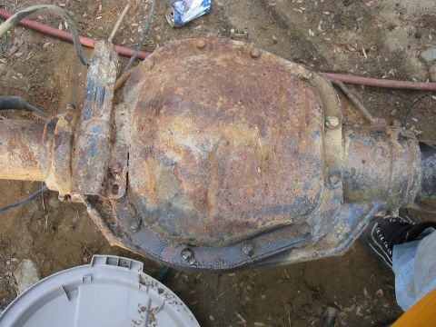 1985 Ford F-350 - A heavily rusted rear axle differential is shown in this close-up view.