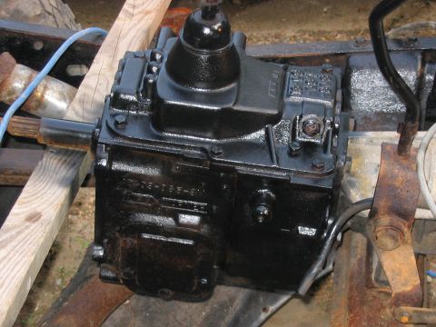1985 Ford F-350 - This image shows a close-up view of a truck's transmission, which is painted black and appears to be recently worked on.