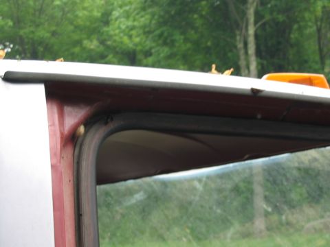 1985 Ford F-350 - The image shows a portion of a truck's cab, focusing on the area around the door frame and roof.