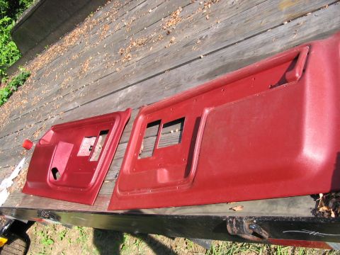 1985 Ford F-350 - Red door panels for a vehicle are displayed outdoors on a wooden deck.