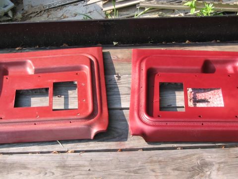 1985 Ford F-350 - Two red interior door panels are laid out on wooden planks.
