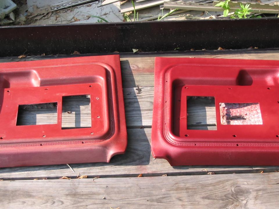 Two red interior door panels with cutouts for window cranks and door handles