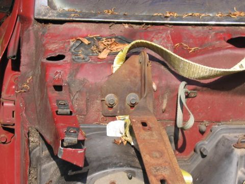 1985 Ford F-350 - The engine bay of a 1985 Ford F-350 shows red paint and significant rust on metal components.