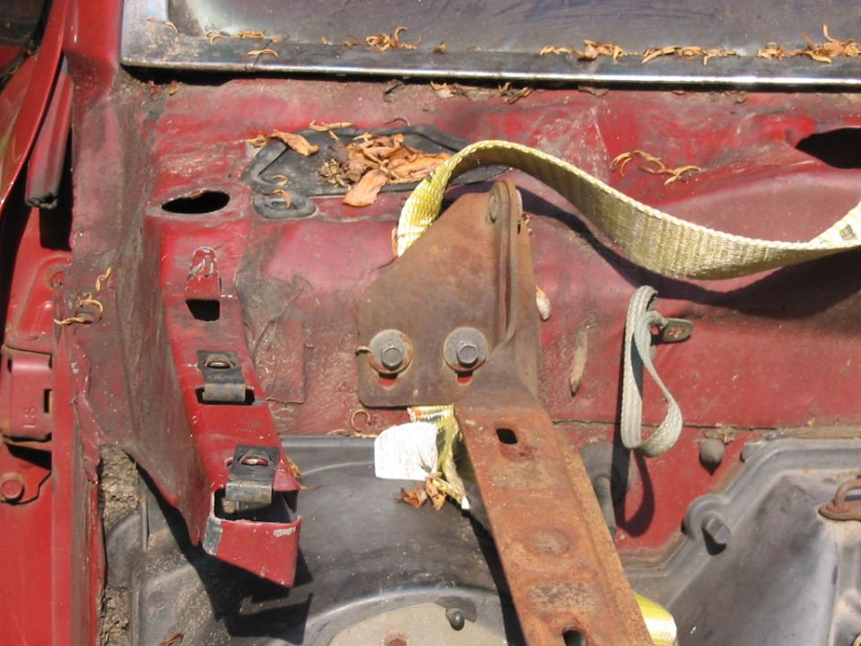 1985 Ford F-350 engine bay with red paint and rusty metal parts