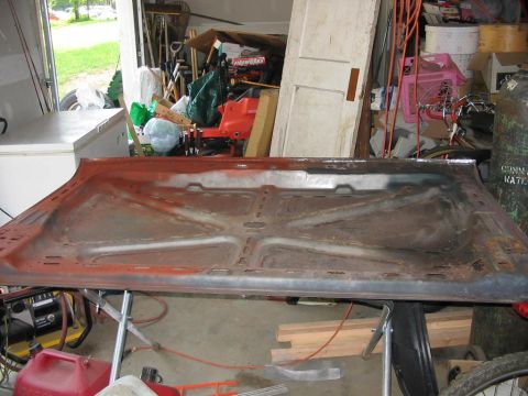 1985 Ford F-350 - The underside of a vehicle hood is visible, supported by sawhorses in a messy garage environment.