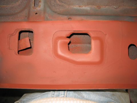 1985 Ford F-350 - Close-up of a vehicle's frame section, showing structural details and cutouts.