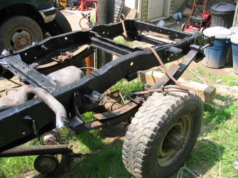 1985 Ford F-350 - The chassis and suspension of a 1985 Ford F-350 are visible, with a large tire mounted.