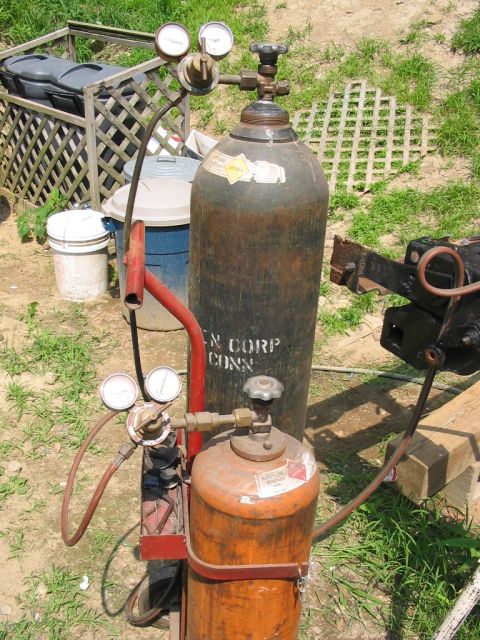 1985 Ford F-350 - Welding gas cylinders and regulators are set up outdoors.
