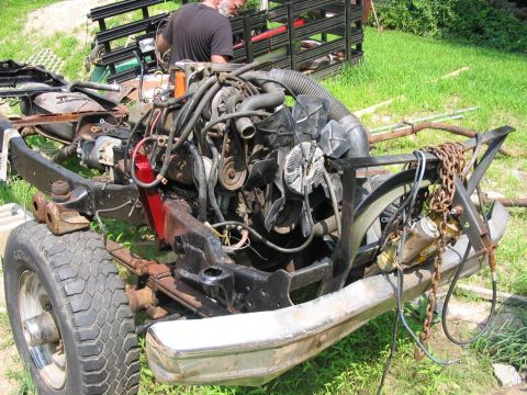 1985 Ford F-350 - The front end of a disassembled truck, showing the engine and chassis components.
