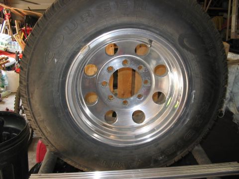 1985 Ford F-350 - A close-up view of a single truck wheel and tire, likely for a heavy-duty vehicle, is shown in a workshop setting.