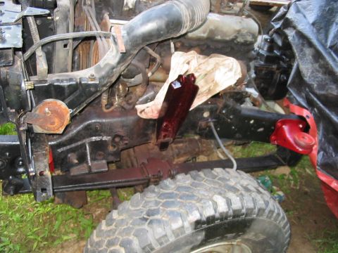 1985 Ford F-350 - Dark red fluid has spilled onto a rag and engine parts in the engine bay.