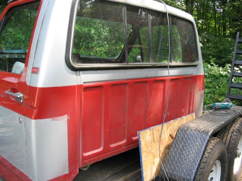1985 Ford F-350 - This 1985 Ford F-350 pickup truck features a two-tone red and silver paint scheme on its bed and cab.