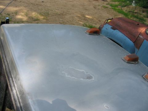 1985 Ford F-350 - Close-up of a truck's roof showing two amber marker lights and some surface imperfections.