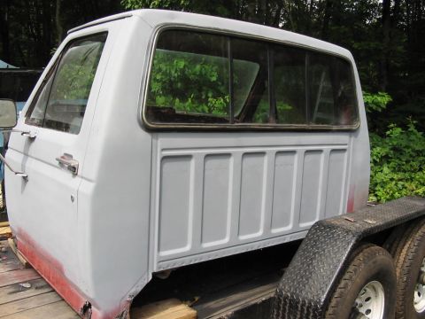 1985 Ford F-350 - This pickup truck cab, likely from the early 1980s, is shown on a trailer with primer visible on its lower sections.