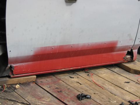 1985 Ford F-350 - The lower door panel of a 1985 Ford F-350 shows significant rust and damage.