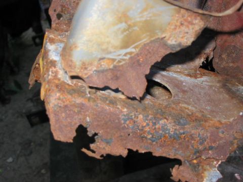 1985 Ford F-350 - Close-up view of severely corroded metal, showing extensive rust damage and structural degradation.