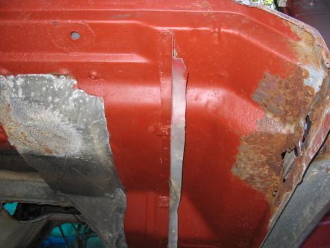 1985 Ford F-350 - This section of a vehicle frame shows significant rust damage and exposed metal.