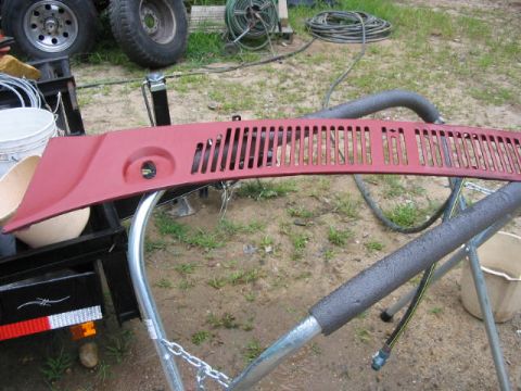1985 Ford F-350 - A red vent grille is shown on a stand, possibly being prepped for painting.