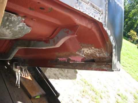 1985 Ford F-350 - Close-up of a corroded vehicle chassis, showing extensive rust damage and repair work in progress.