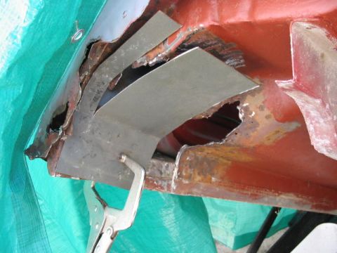 1985 Ford F-350 - Repairing rusted metal on a vehicle part, with a clamp holding a patch in place.