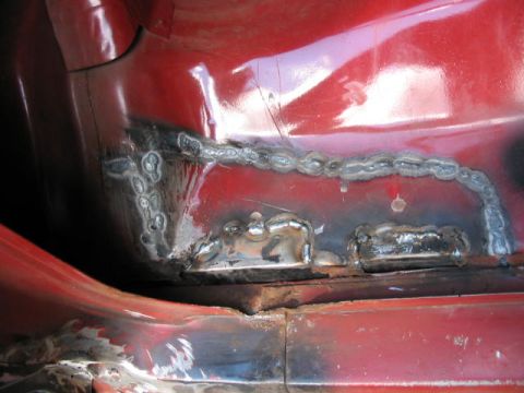 1985 Ford F-350 - This photo shows interior metal repair work with visible welds on a red vehicle.
