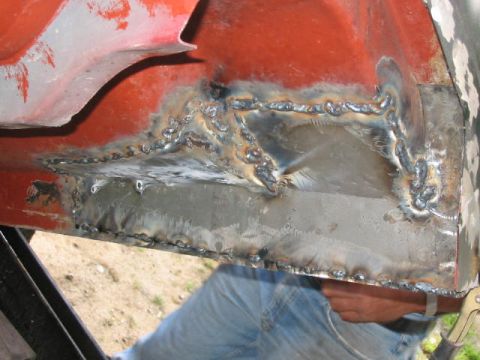 1985 Ford F-350 - Extensive welding repairs are visible on the lower body panel of a vehicle, obscuring specific year identification.