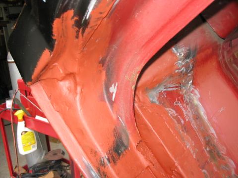 1985 Ford F-350 - Close-up of a vehicle's inner body panel undergoing repair, revealing primer and metalwork.