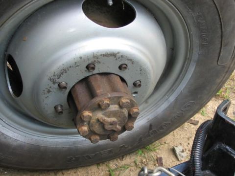 1985 Ford F-350 - Close-up of the front wheel hub and Goodyear radial tire, consistent with a 1985 Ford F-350.
