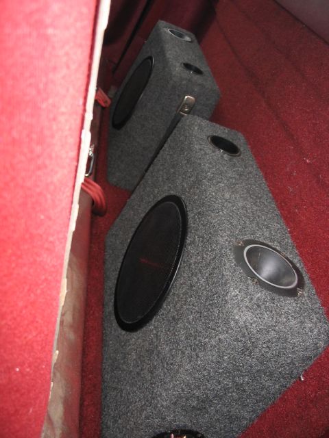 1985 Ford F-350 - Two speaker boxes are installed in the interior of a vehicle with red carpeting.