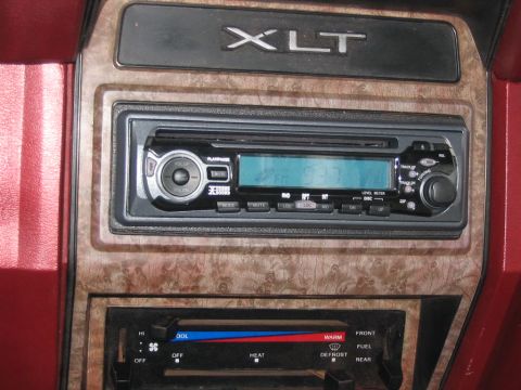 1985 Ford F-350 - The interior of a vehicle shows the dashboard with climate controls and an aftermarket radio unit.