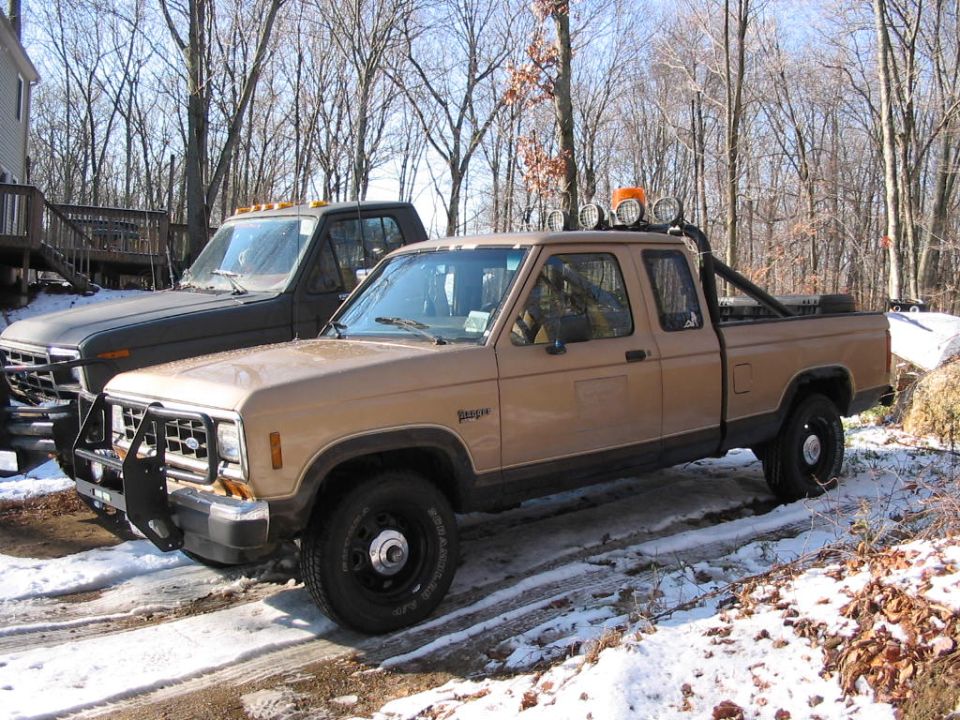 Tan 1988 Ford Ranger pickup truck with bull bar and roll bar