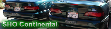 1993 Ford Taurus - Rear view of two 1993 Ford Taurus SHO sedans, one slightly ahead of the other.