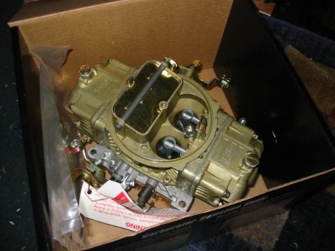 1985 Ford Crown Victoria LTD - A new carburetor is shown inside its packaging, ready for installation.
