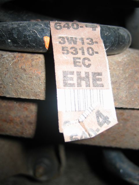 1985 Ford LTD Crown Victoria - A close-up view of a part with a label containing alphanumeric characters and a barcode.