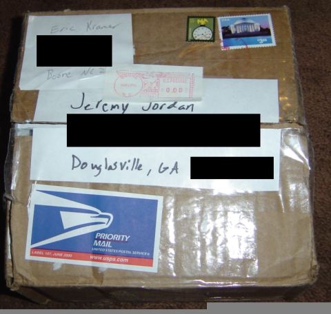 1986 Ford Bronco - A cardboard box is prepared for shipping, handwritten addresses and postal service labels.
