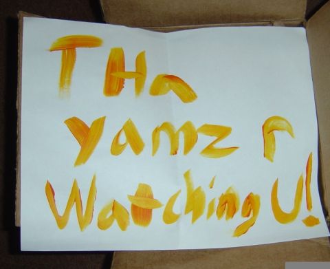 1986 Ford Bronco - A handwritten note with orange paint reads 'Tha Yamz r Watching U!'.