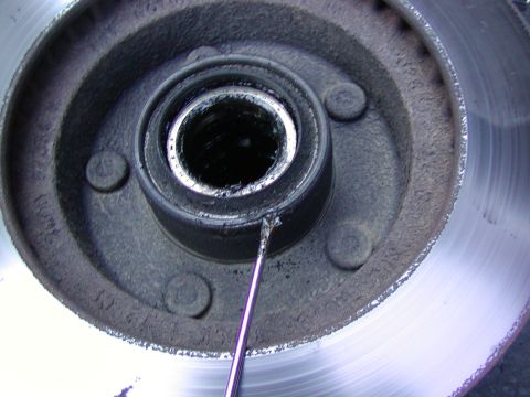 1991 Ford Bronco - pry off the wheel seal with a small screw driver and a hammer.